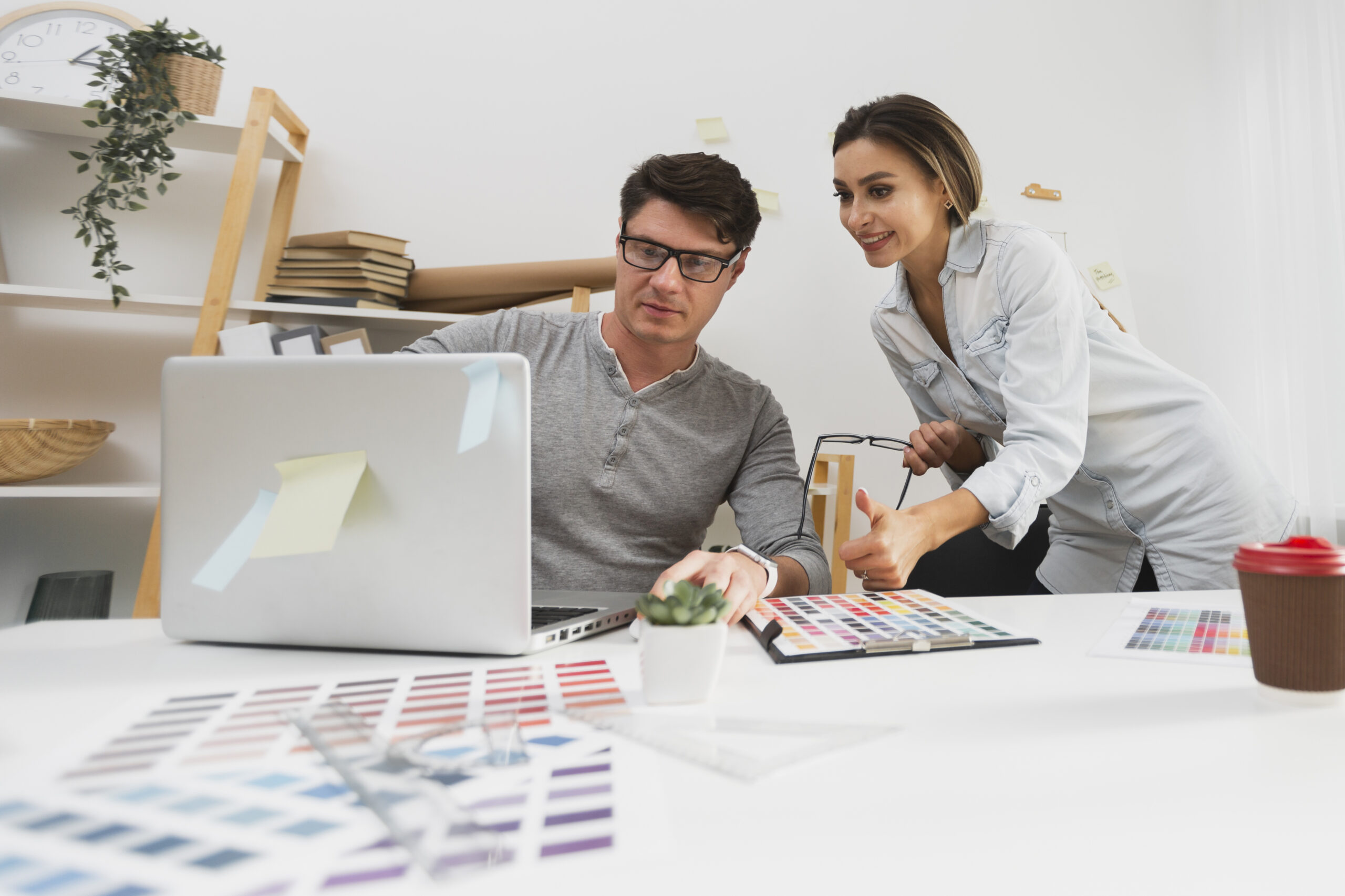 front-view-man-showing-something-laptop-his-colleague